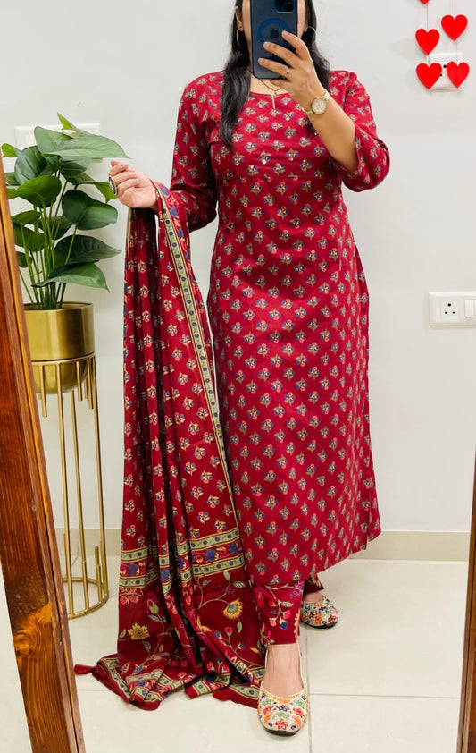 Person wearing a red traditional outfit with a matching dupatta, standing in front of a mirror.