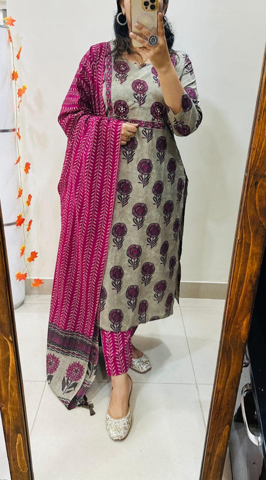 Person wearing a patterned kurta with a pink dupatta in front of a mirror.