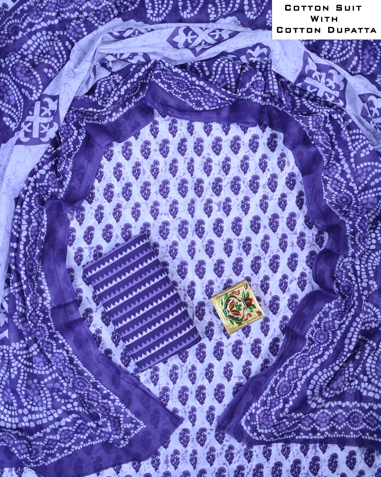 Cotton suit with a matching dupatta featuring intricate patterns on a blue and white background.