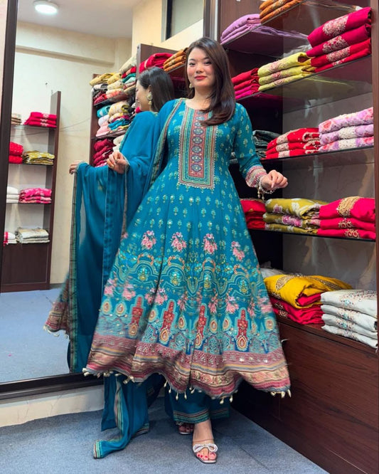 Woman in a colorful traditional outfit standing in a store with folded fabrics.